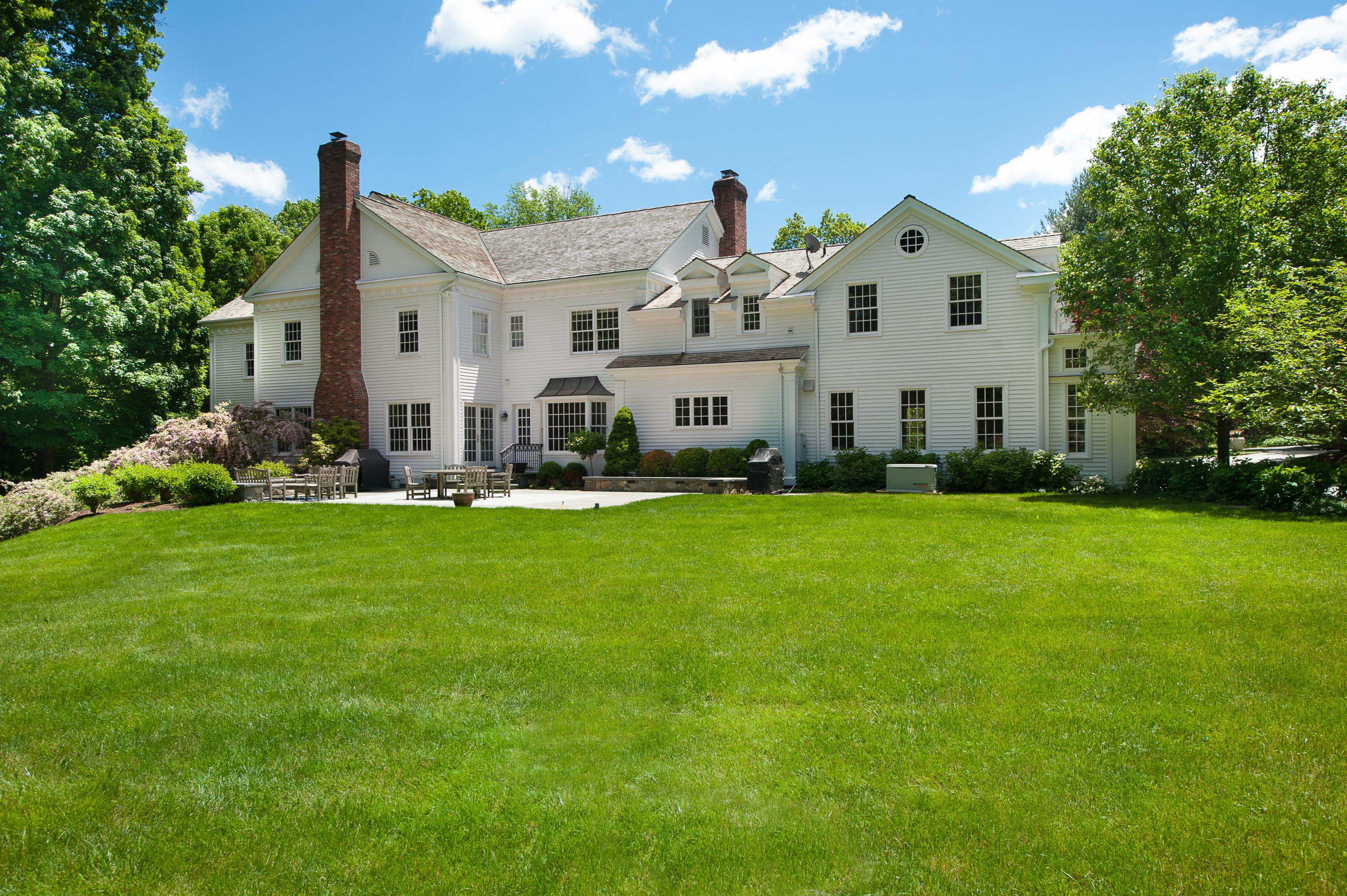 399 Wahackme Road New Canaan, CT 06840 - Photo 30 of 35 a front view of a house with garden and porch