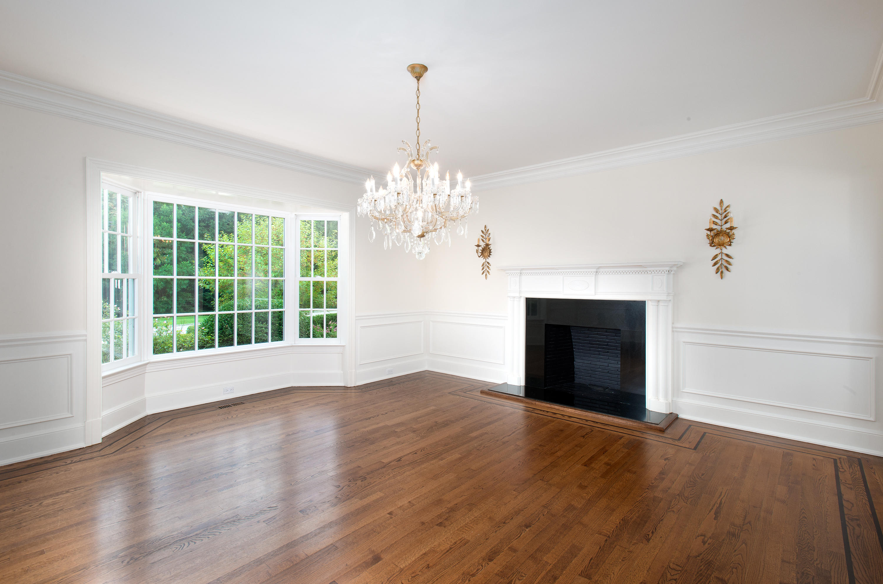 399 Wahackme Road New Canaan, CT 06840 - Photo 9 of 35 a view of a livingroom with a chandelier and fireplace