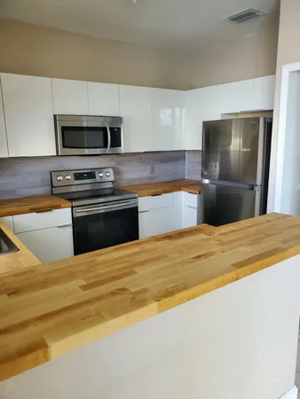 a kitchen with stainless steel appliances a stove and a refrigerator