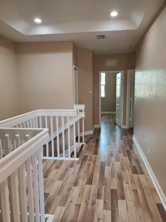 a view of gallery with wooden floor