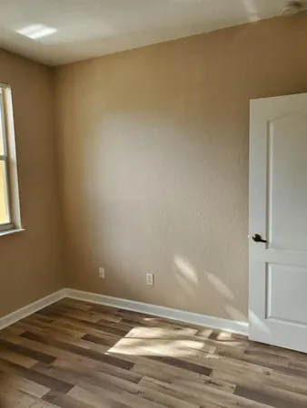 a view of a room with wooden floor