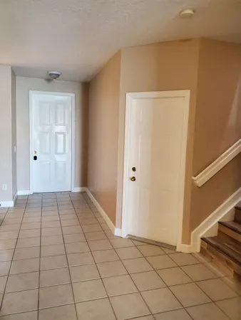 a view of a livingroom with an empty space and a stove top oven
