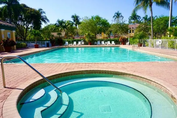 a swimming pool with outdoor seating and garden