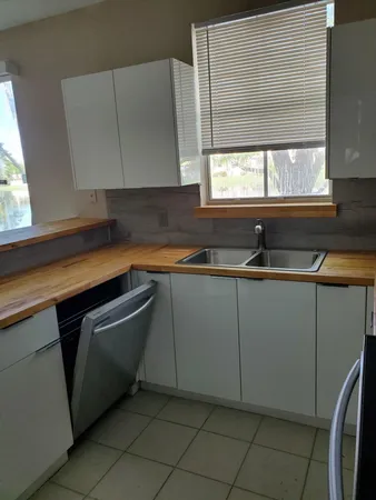 a kitchen with sink cabinets and window
