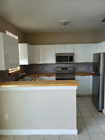 a kitchen with stainless steel appliances a refrigerator a stove a sink and a stove