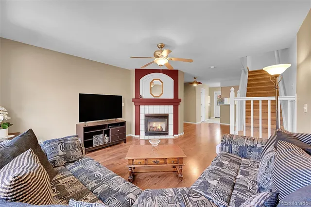 a living room with furniture a fireplace and a flat screen tv