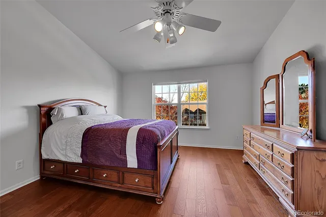 a bedroom with a bed and a flat tv screen on dresser