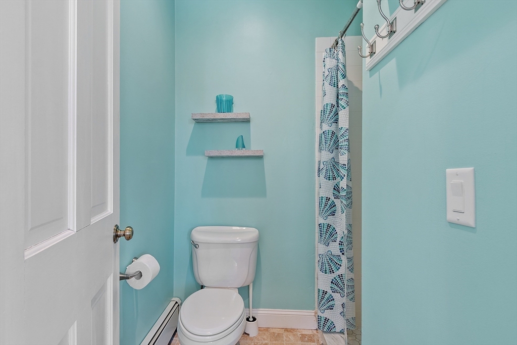 50 Castle View Drive Gloucester, MA 01930 - Photo 14 of 42 a white toilet sitting next to a shower curtain