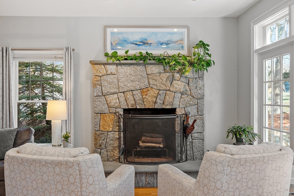 50 Castle View Drive Gloucester, MA 01930 - Photo 16 of 42 a living room with furniture a chandelier and a fireplace