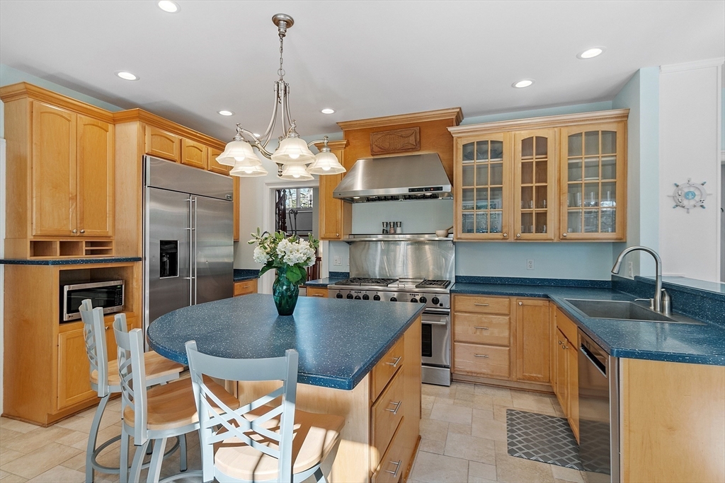 50 Castle View Drive Gloucester, MA 01930 - Photo 21 of 42 a kitchen with stainless steel appliances granite countertop a sink a stove and a refrigerator