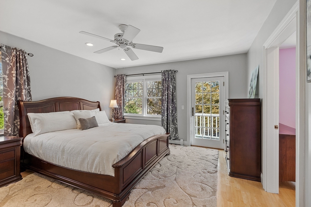 50 Castle View Drive Gloucester, MA 01930 - Photo 27 of 42 a bedroom with a large bed and a chandelier