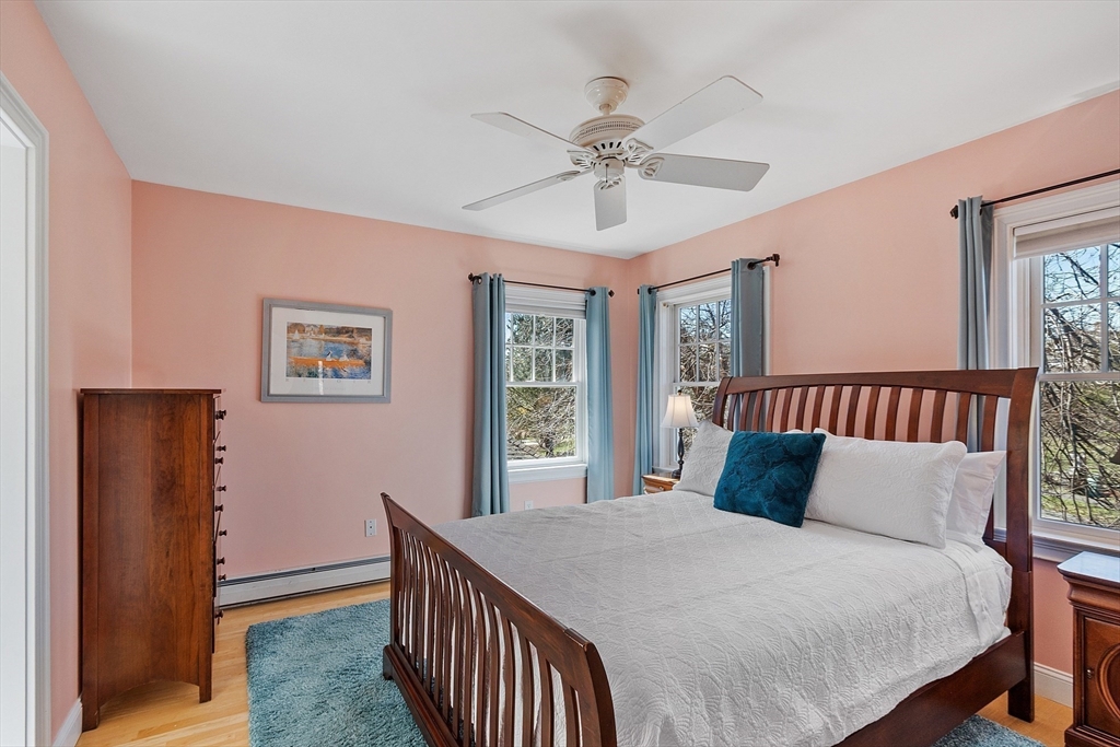 50 Castle View Drive Gloucester, MA 01930 - Photo 33 of 42 a bedroom with a large bed and a chandelier