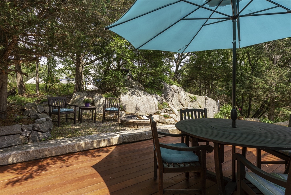 50 Castle View Drive Gloucester, MA 01930 - Photo 7 of 42 a view of a table and chairs under an umbrella