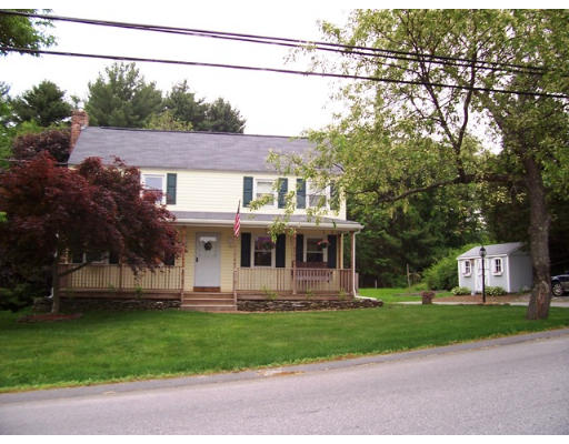 a front view of a house with a garden and yard