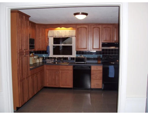 705 Wheeler Road Dracut, MA 01826 - Photo 4 of 11 a kitchen with stainless steel appliances granite countertop a stove a sink and a microwave