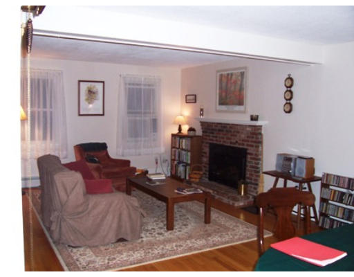 705 Wheeler Road Dracut, MA 01826 - Photo 5 of 11 a living room with furniture and a fireplace