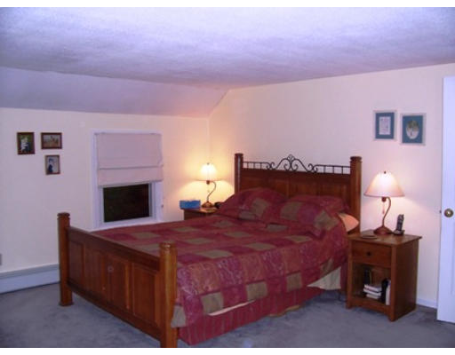 705 Wheeler Road Dracut, MA 01826 - Photo 7 of 11 a bedroom with a bed and a fireplace