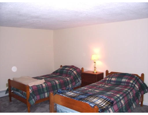 705 Wheeler Road Dracut, MA 01826 - Photo 9 of 11 a bedroom with two beds and a lamp on desk