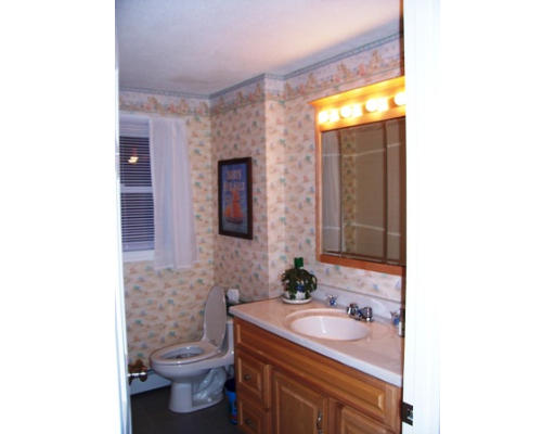 705 Wheeler Road Dracut, MA 01826 - Photo 10 of 11 a bathroom with a toilet sink and mirror
