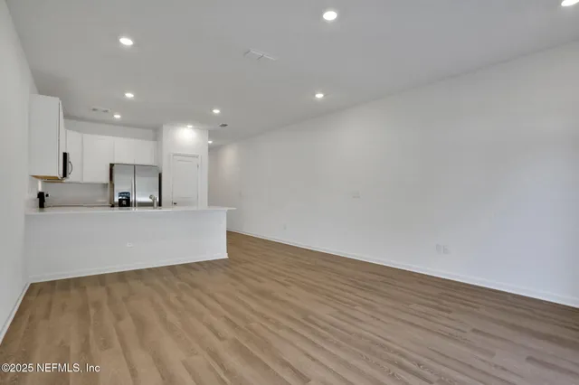 a view of kitchen with wooden floor and window