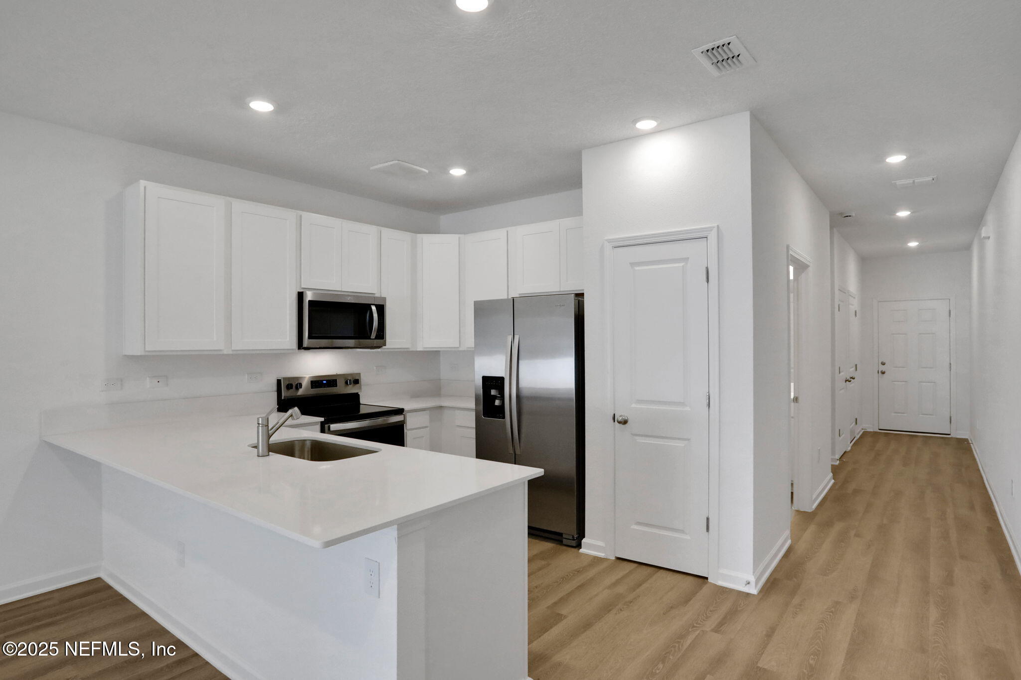 739 Sailor Grove Lane Jacksonville, FL 32221 - Photo 15 of 30 a kitchen with white cabinets and stainless steel appliances