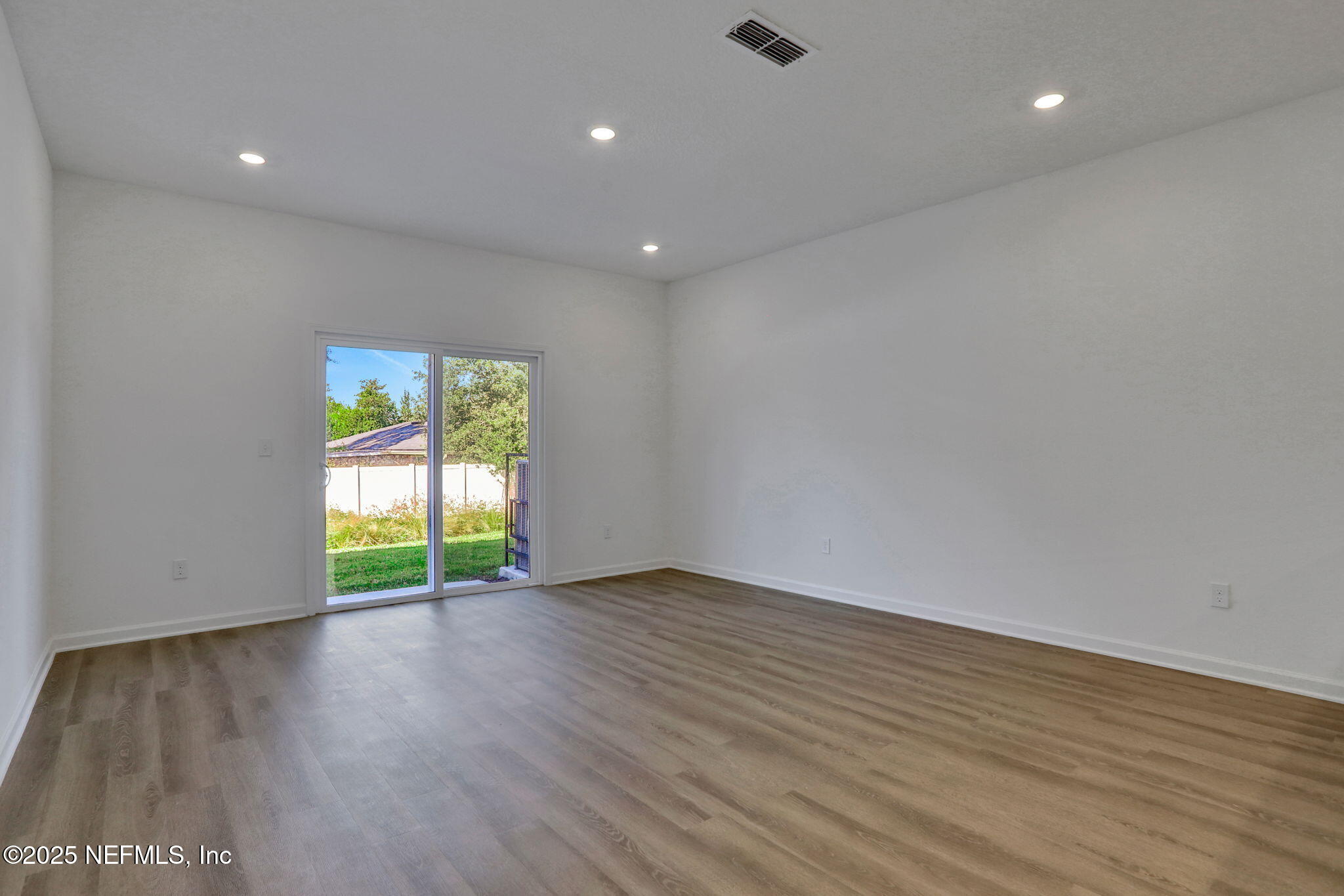 739 Sailor Grove Lane Jacksonville, FL 32221 - Photo 8 of 30 a view of an empty room with wooden floor and a window