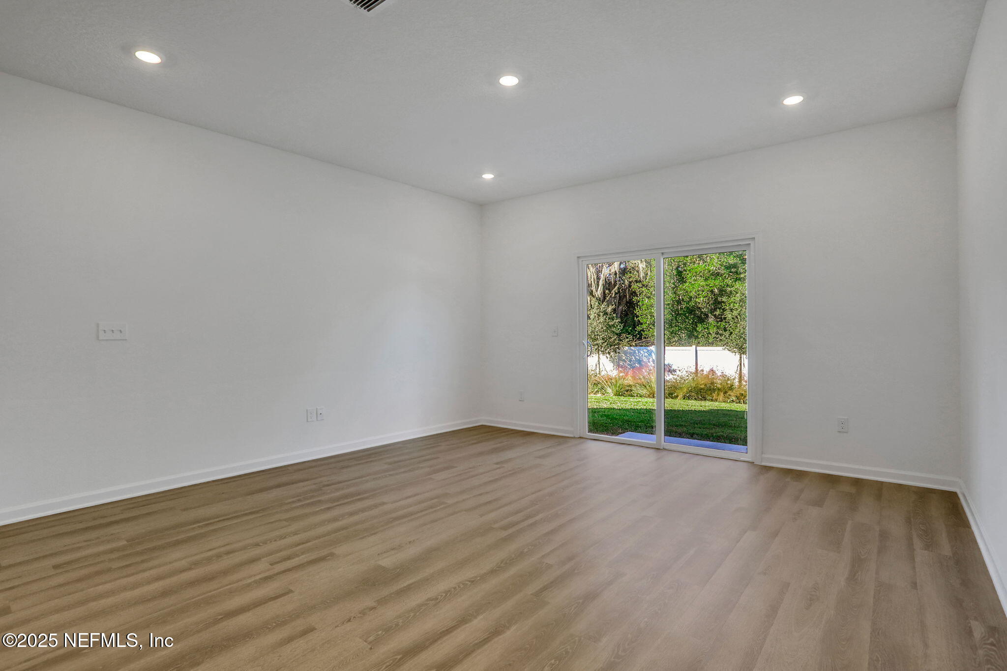 739 Sailor Grove Lane Jacksonville, FL 32221 - Photo 9 of 30 a view of an empty room with wooden floor and a window