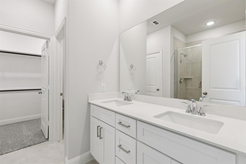 1318 Middlebrook Drive Forney, TX 75126 - Photo 12 of 39 a bathroom with a double vanity sink mirror and double