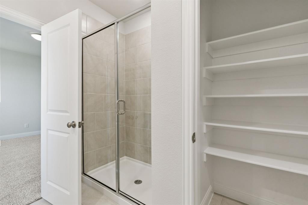 1318 Middlebrook Drive Forney, TX 75126 - Photo 13 of 39 a bathroom with a glass shower door