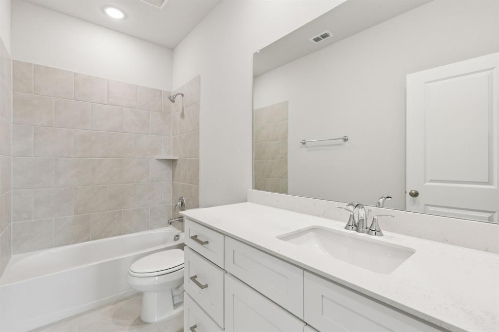 1318 Middlebrook Drive Forney, TX 75126 - Photo 15 of 39 a bathroom with a sink a toilet and shower