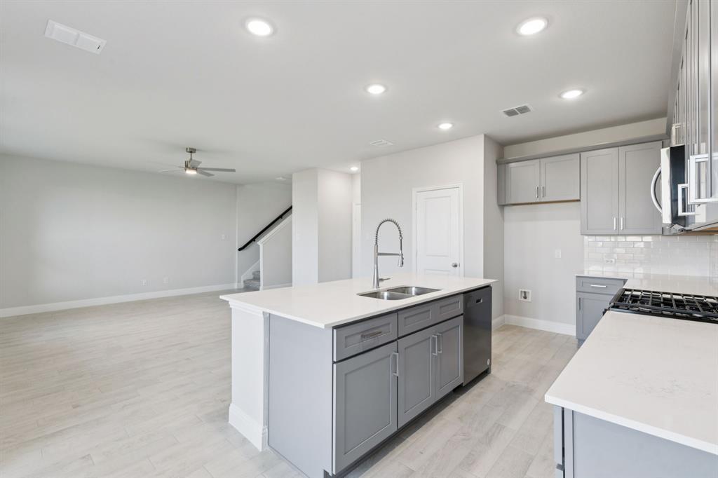 1318 Middlebrook Drive Forney, TX 75126 - Photo 6 of 39 a kitchen that has a sink a stove and cabinets