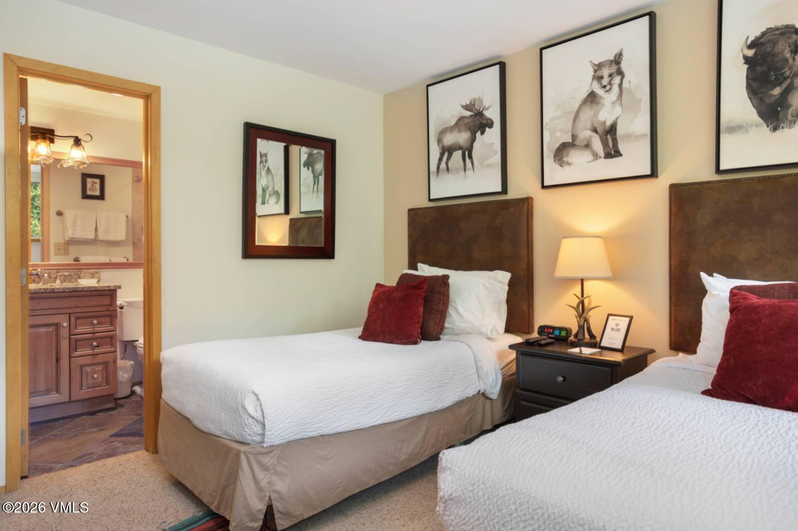 1100 North Frontage Road West, Unit 1519 Vail, CO 81657 - Photo 14 of 38 a bedroom with two beds and painting on the wall