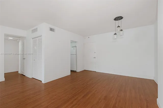 a view of a room with wooden floor