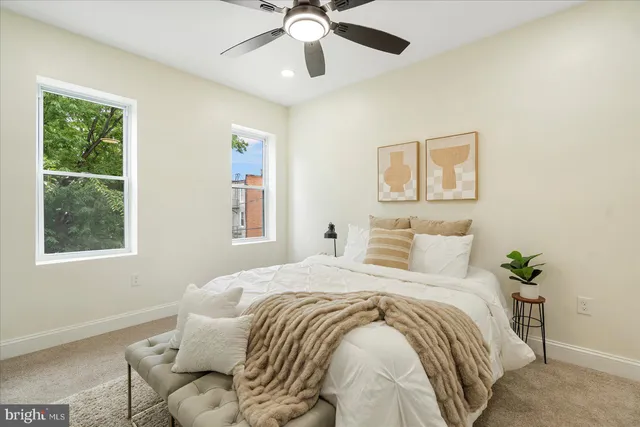 a bedroom with a bed and a window