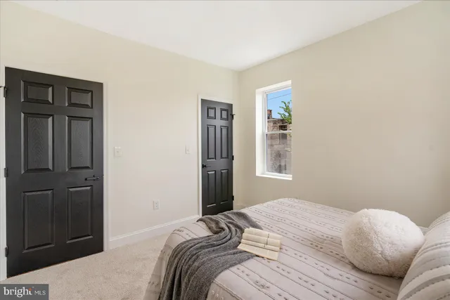 a bedroom with a bed and a window