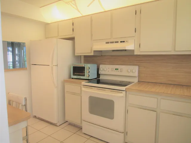 a kitchen with appliances cabinets and a counter top space