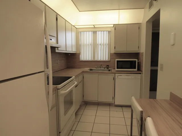 a kitchen with a stove refrigerator and cabinets