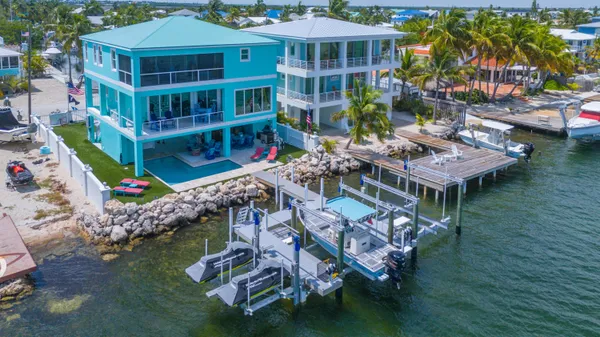 an aerial view of a house with a yard