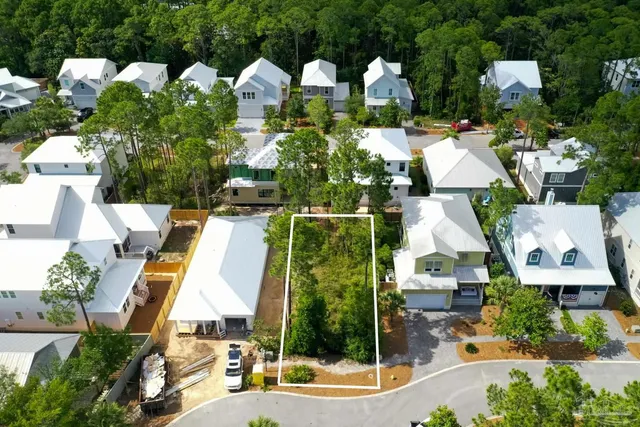 an aerial view of multiple houses with yard