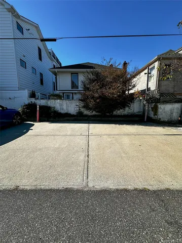 a view of a car park in front of a house