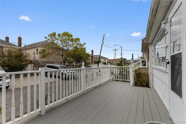 a view of a balcony with wooden floor