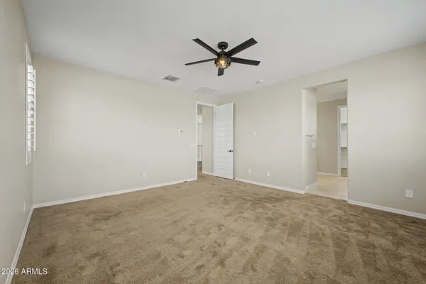 a view of a livingroom with a ceiling fan and window