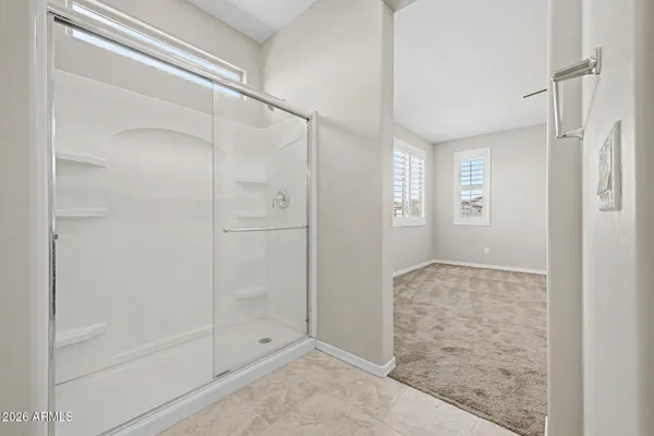 a bathroom with a glass shower door