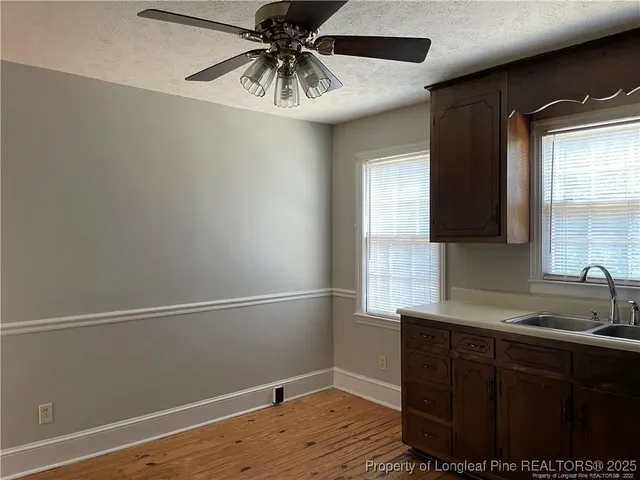 a view of a kitchen with a sink and cabinets