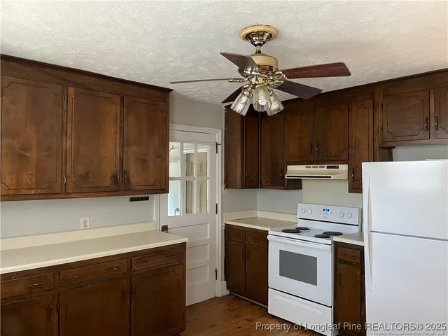a kitchen with stainless steel appliances a stove a refrigerator and cabinets
