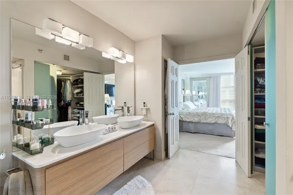 a bedroom with a large bed and a mirror