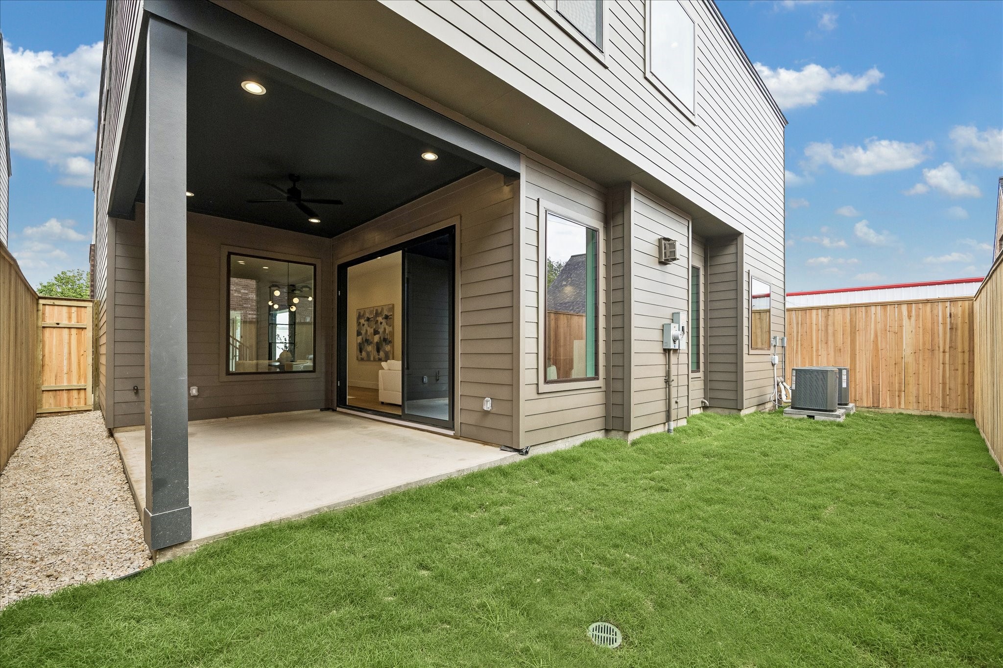 335 Harvard Street Houston, TX 77007 - Photo 31 of 35 Backyard has a covered patio with a ceiling fan.