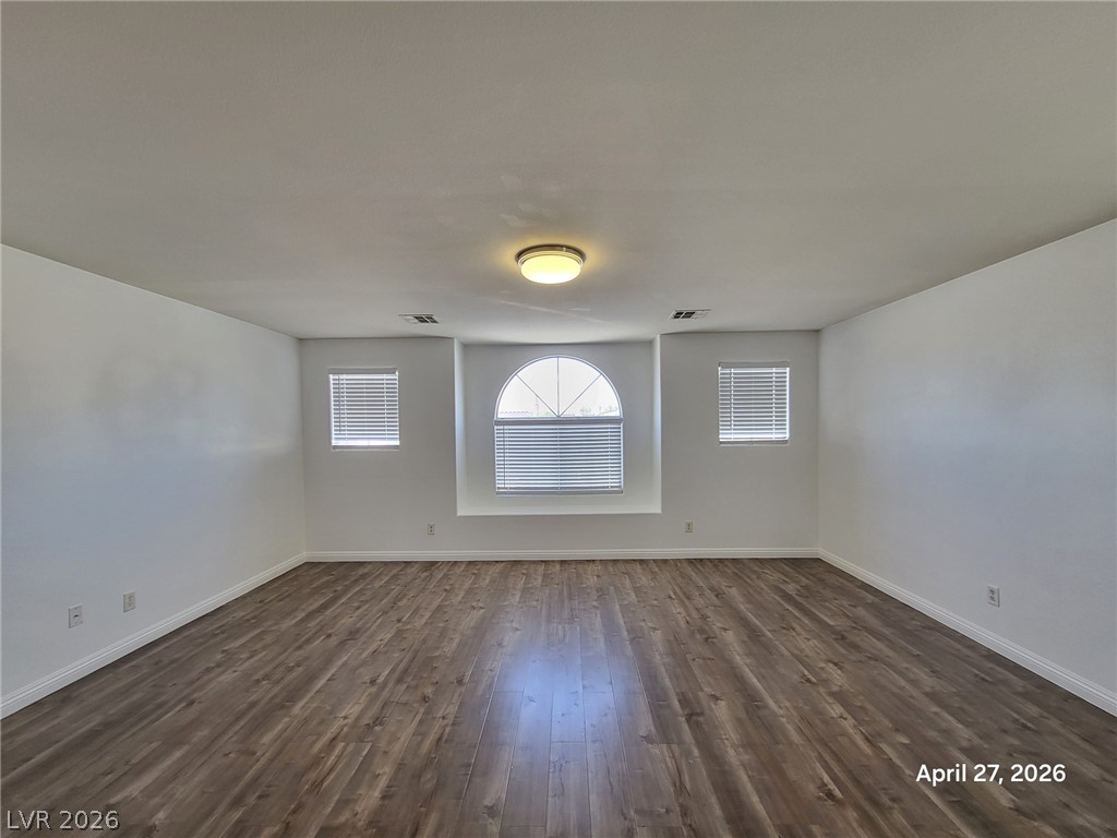 4548 Flaming Ridge Trail Las Vegas, NV 89147 - Photo 7 of 21 Gleaming wood flooring complements the arched window detail in this versatile room.