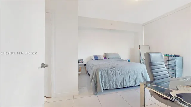 a bedroom with a bed and a night stand