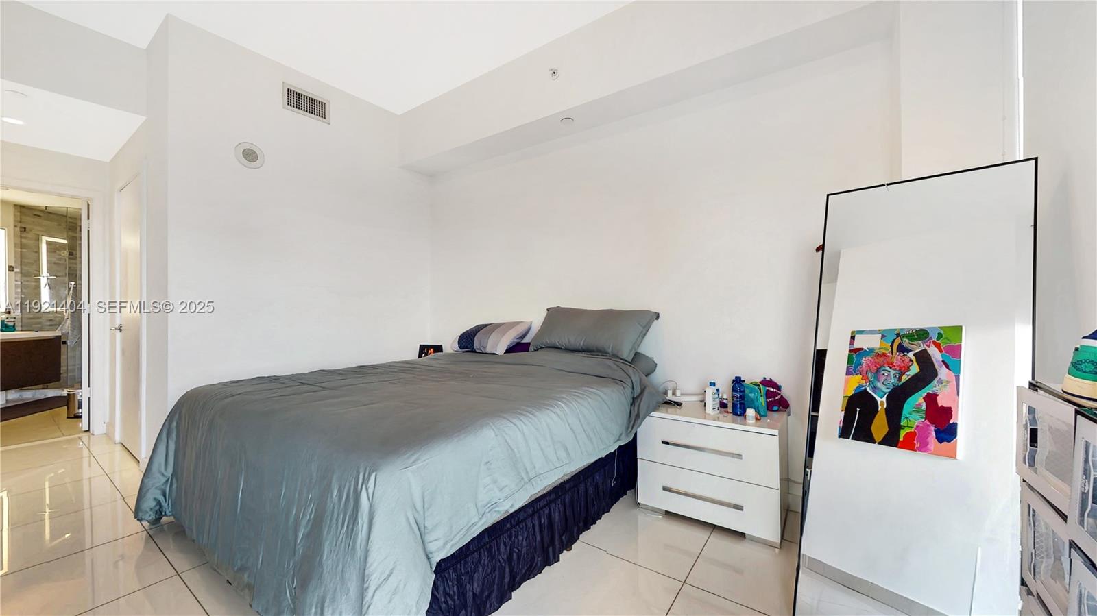 851 Northeast 1st Avenue, Unit 1508 Miami, FL 33132 - Photo 13 of 43 a bed room with a bed and a white cabinet
